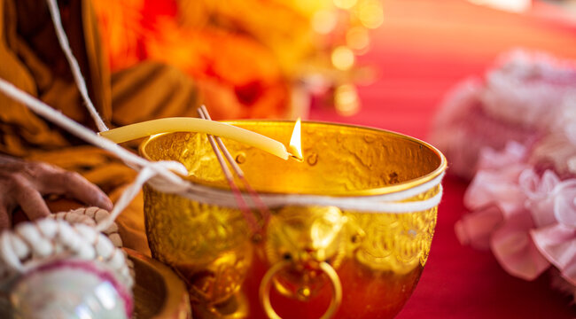 Holy Water Bowl And Candles,Thai Traditional Style Making Holy Water In From Buddha Monk. Close-up In Hand Buddhism Monk Holding Candle Lighting And Drippings Into Holy Water Bowl.