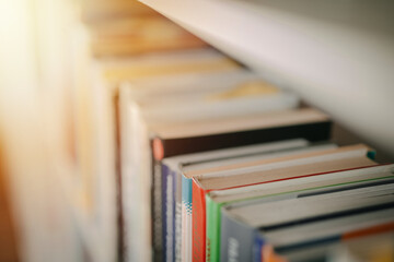 Open book on a black table. Library in the background. Book on table close up.