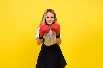 An adorable little girl boxer practicing punches in studio