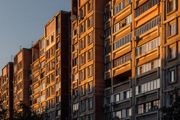 Fototapeta premium Panel house on a summer evening with sunset rays