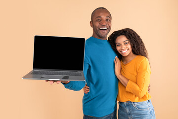 Check this website. Excited middle aged man and young woman showing laptop with black blank screen, mock up