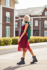 Portrait of young blonde woman posing in autumn street