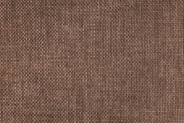 Fototapeta na wymiar Jacquard woven upholstery, brown coarse fabric texture. Textile background, furniture textile material, wallpaper, backdrop. Cloth structure close up.