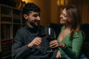 Young couple drinking wine at home