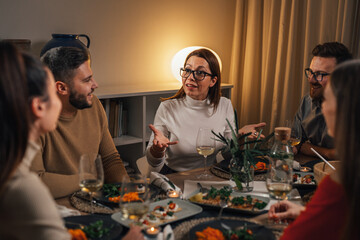 Woman talks to her friends on a dinner party