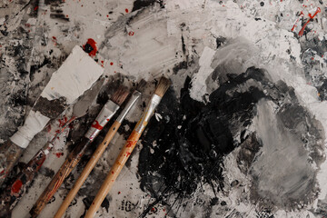 Obraz premium Artist brush mixed color oil painting on palette. Macro artist's palette. Palette with paintbrush. Artist paints a picture of oil paints. Art palette