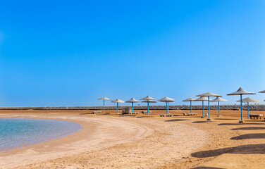 Umbrella on the beach. Holiday relaxation with turquoise sea and blue sky landscape. Summer vacation travel concept