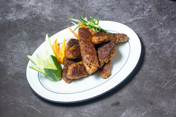 Spicy fish tikka kabab with salad served in dish isolated on grey background top view of indian and bangladesh food
