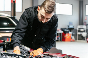 Car mechanic working in a garage