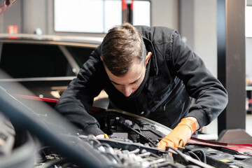 Car mechanic working in a garage