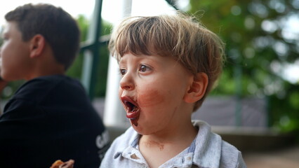 Messy little baby toddler covered with chocolate ice-cream, dirty mouth2