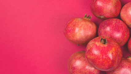 Sweet pomegranate on red background.