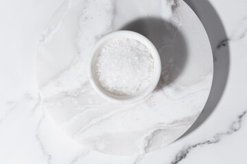 A cup of sea salt on a white background