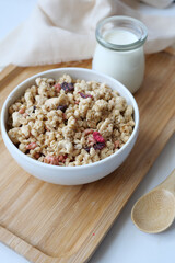 granola Musli and glass of milk on table 