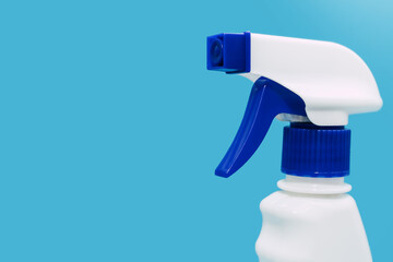 Plastic white spray on a blue background. Detergent for cleaning and disinfecting rooms, cleaning...