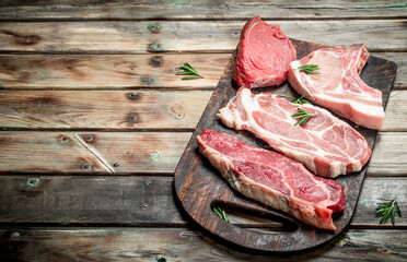 Raw meat. Beef and pork steaks on the Board.