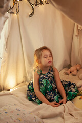 the girl is playing and reading a book in the hut
