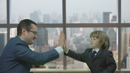 Man and kid shaking hands and other gestures at the business office