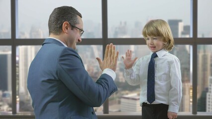 Father and son with suit shake hands, give five, different generation agreement