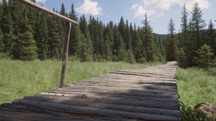 Wooden footbridge path crossing a mountain peat bog