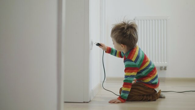 Little kid insert the plug into the socket, risk of electric shock