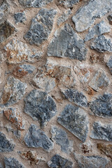 Solid stone wall texture with uneven rough blocks