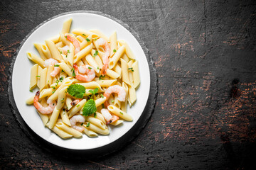 Pasta with shrimp and mint leaves.