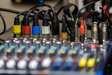 Fototapeta na wymiar Audio wire plugs plugged into the audio mixing console
