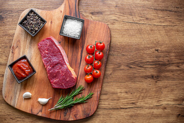 raw beef steak on wooden background with copy space for your text