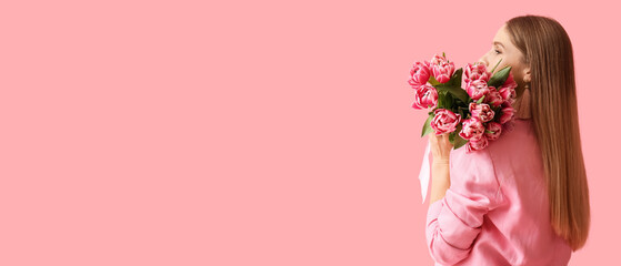 Beautiful woman holding bouquet of flowers on pink background with space for text. International...
