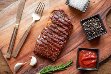grilled beef steak on wooden background 
