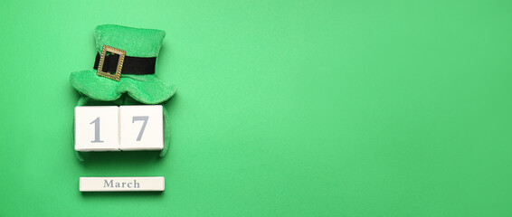 Leprechaun's hat and calendar with date of St. Patrick's Day on green background with space for text