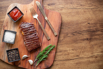grilled beef steak on wooden background with copy space for your text