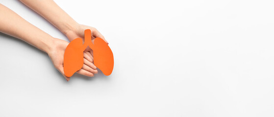 Female hands holding paper lungs on white background with space for text