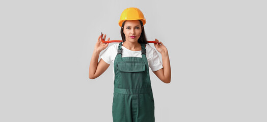 Female worker on light background. Concept of feminism