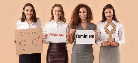 Young women on beige background. Concept of feminism