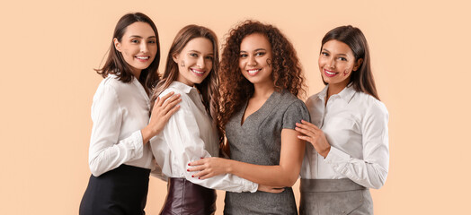Pretty young women on beige background. Concept of feminism