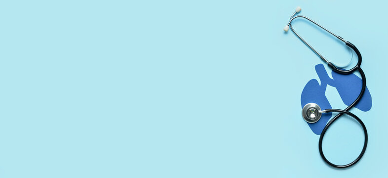 Paper lungs and stethoscope on light blue background with space for text