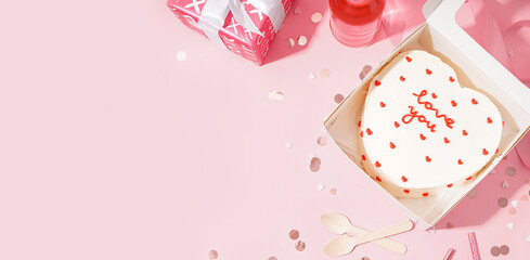 Box with heart-shaped bento cake on pink background with space for text. Valentine's Day celebration