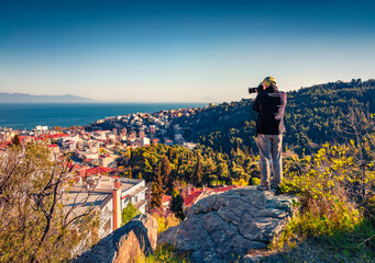 Photographer takes picture of Kavala port, principal town of eastern Macedonia and the capital of...