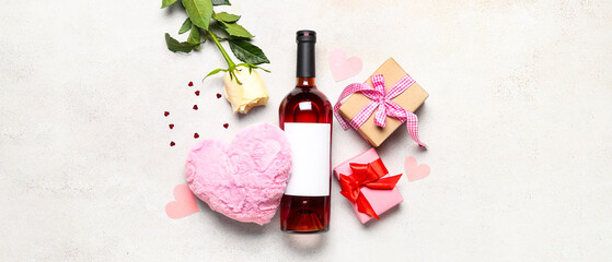 Bottle of wine, gift boxes, hearts and rose flower on white background. Valentine's Day celebration