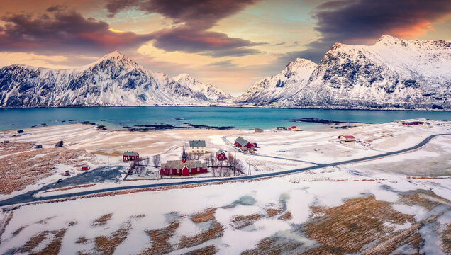 Extraordinary spring scene of Lofoten Islands. View from flying drone of Flakstad village with Hustinden mount on background, Norway, Europe. Impressive morning landscape with Flakstad church.