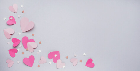 Paper hearts and sprinkles on grey background with space for text. Valentines Day celebration
