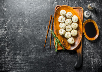 Freshly cooked dumplings manta on a plate with rosemary.