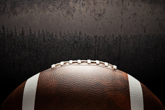 American football ball on rusty iron background with space for text.