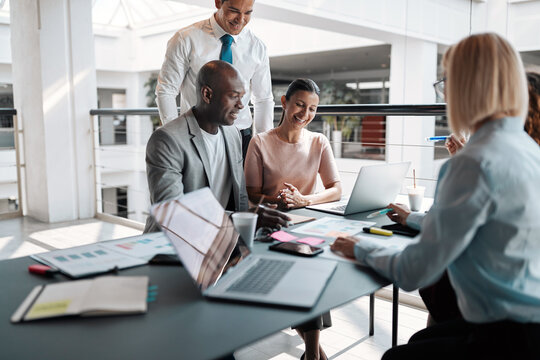 Diverse businesspeople smiling during an office meeting