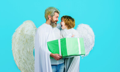 Valentines day. Little angel child boy and father in white wing with Valentine present. Cute angels.