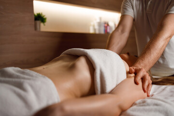 Obraz na płótnie Canvas Masseur massaging woman's shoulders in spa salon