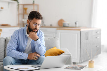 Male psychologist with laptop video chatting with patient at home