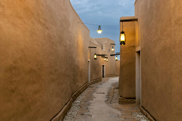 A street with lanterns in At-Turaif UNESCO World Heritage site, Diriyah, Saudi Arabia - obrazy, fototapety, plakaty